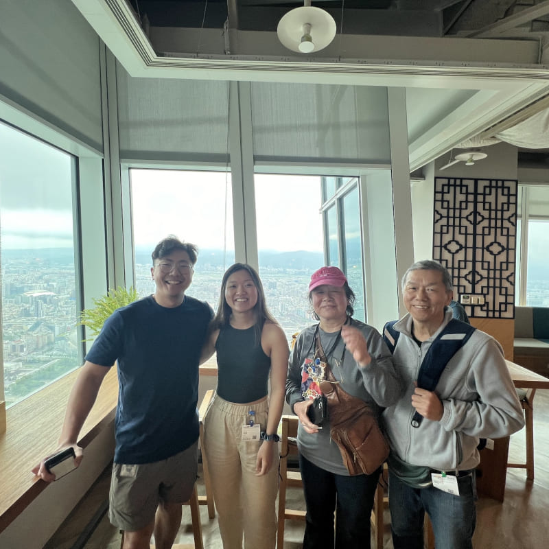 A group of people in front of a window of a tall building