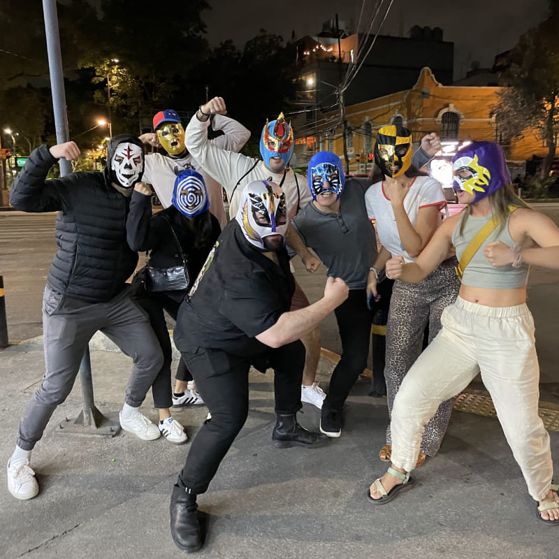 a group of people wearing lucha masks and posing as if they are fighting