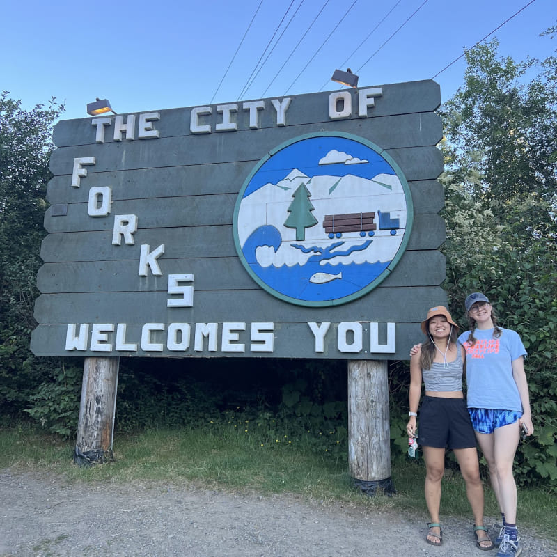 Collen and Cindy in front of the Forks welcome sign