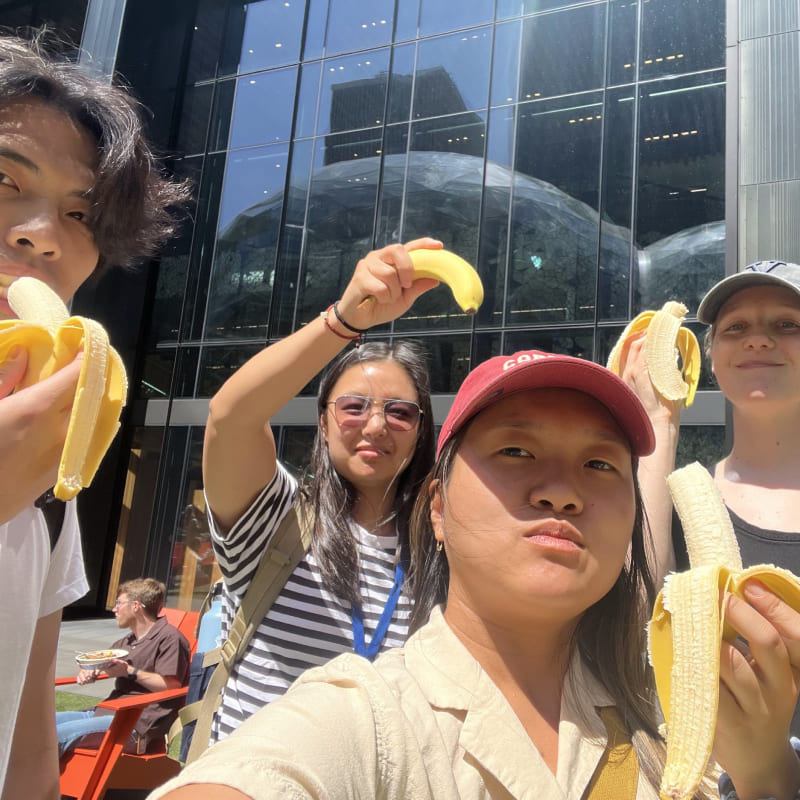 A group of people each holding bananas