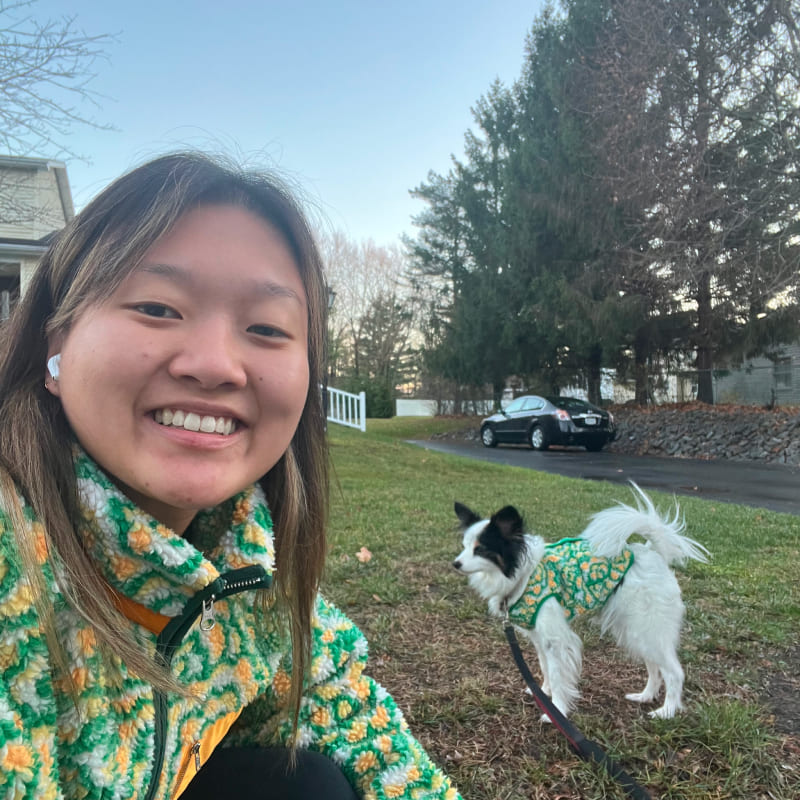 A girl and her dog with matching green fleeces