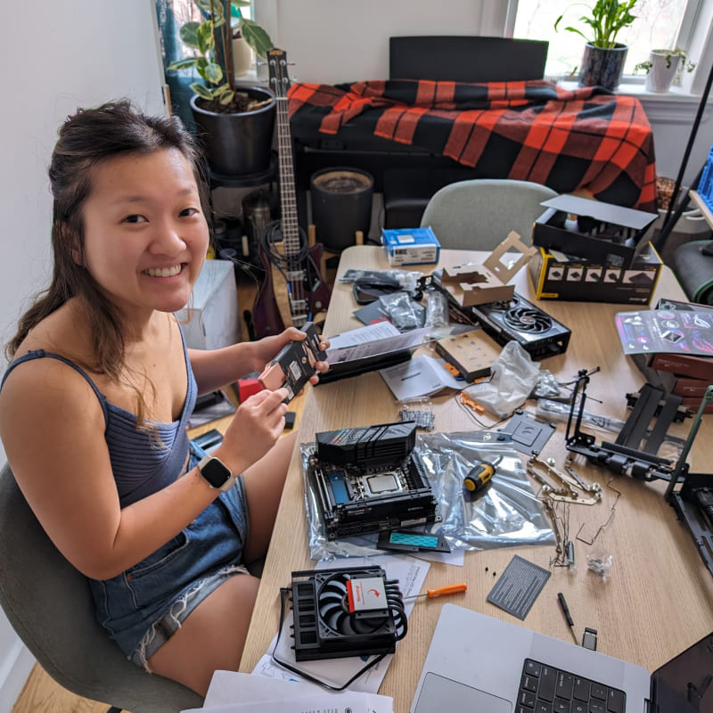 a girl at a table filled with computer components