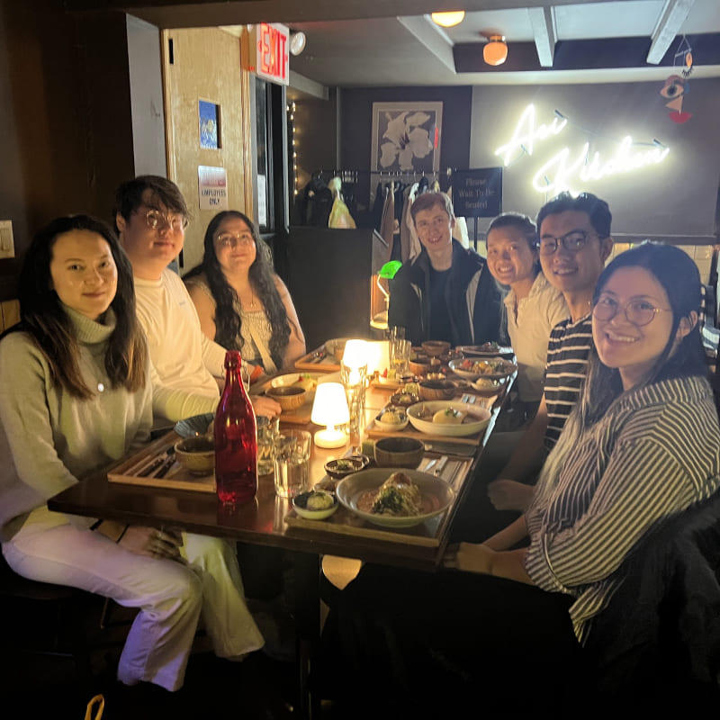 A group of people in a dimly lit restaurant