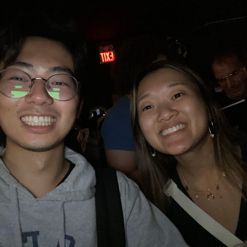 A selfie of two people in a dark room