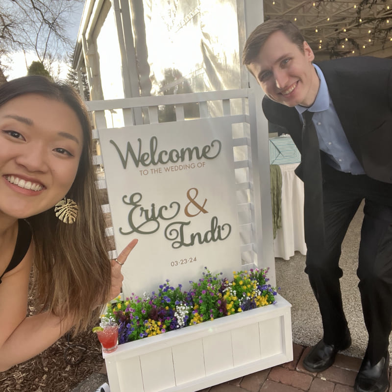 A selfie of a couple in front of sign